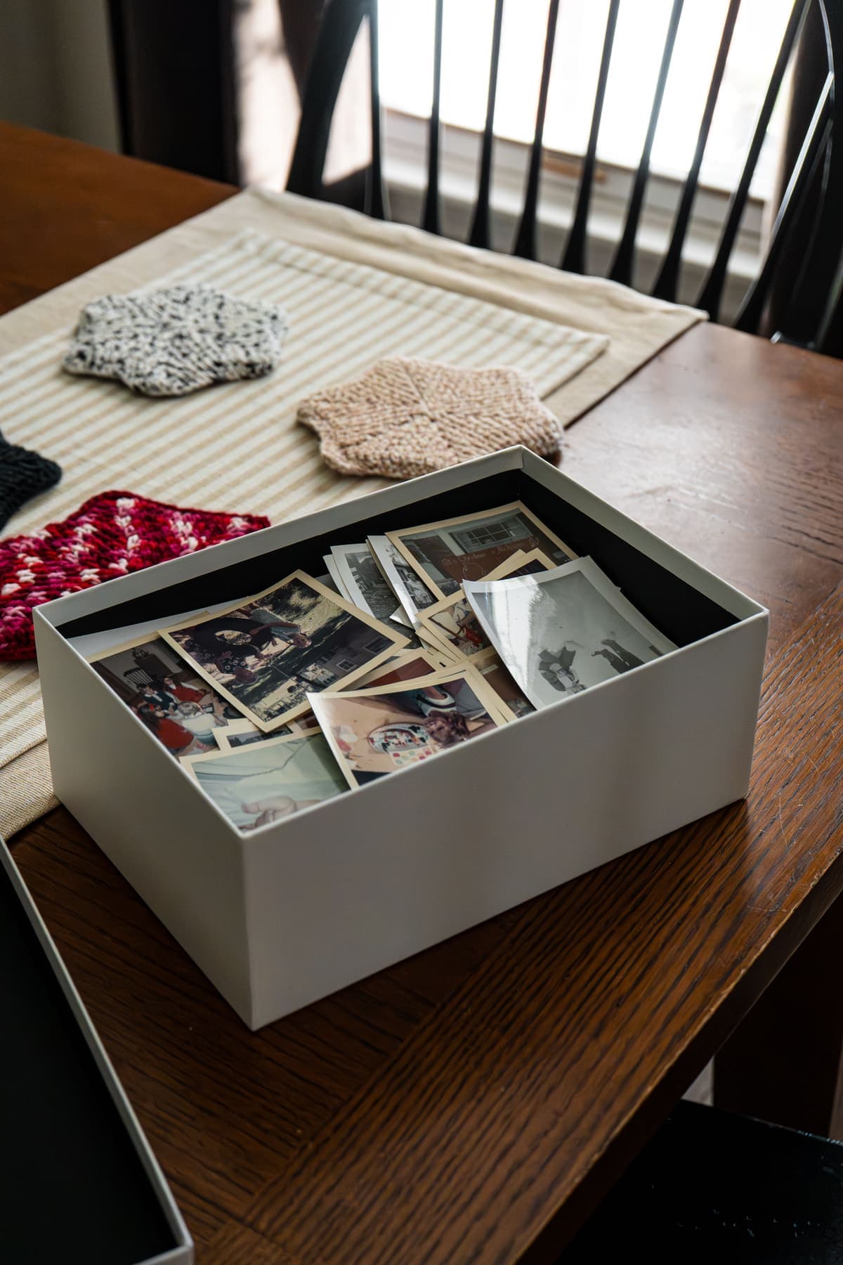 A shoebox of old family photographs, waiting to be sorted